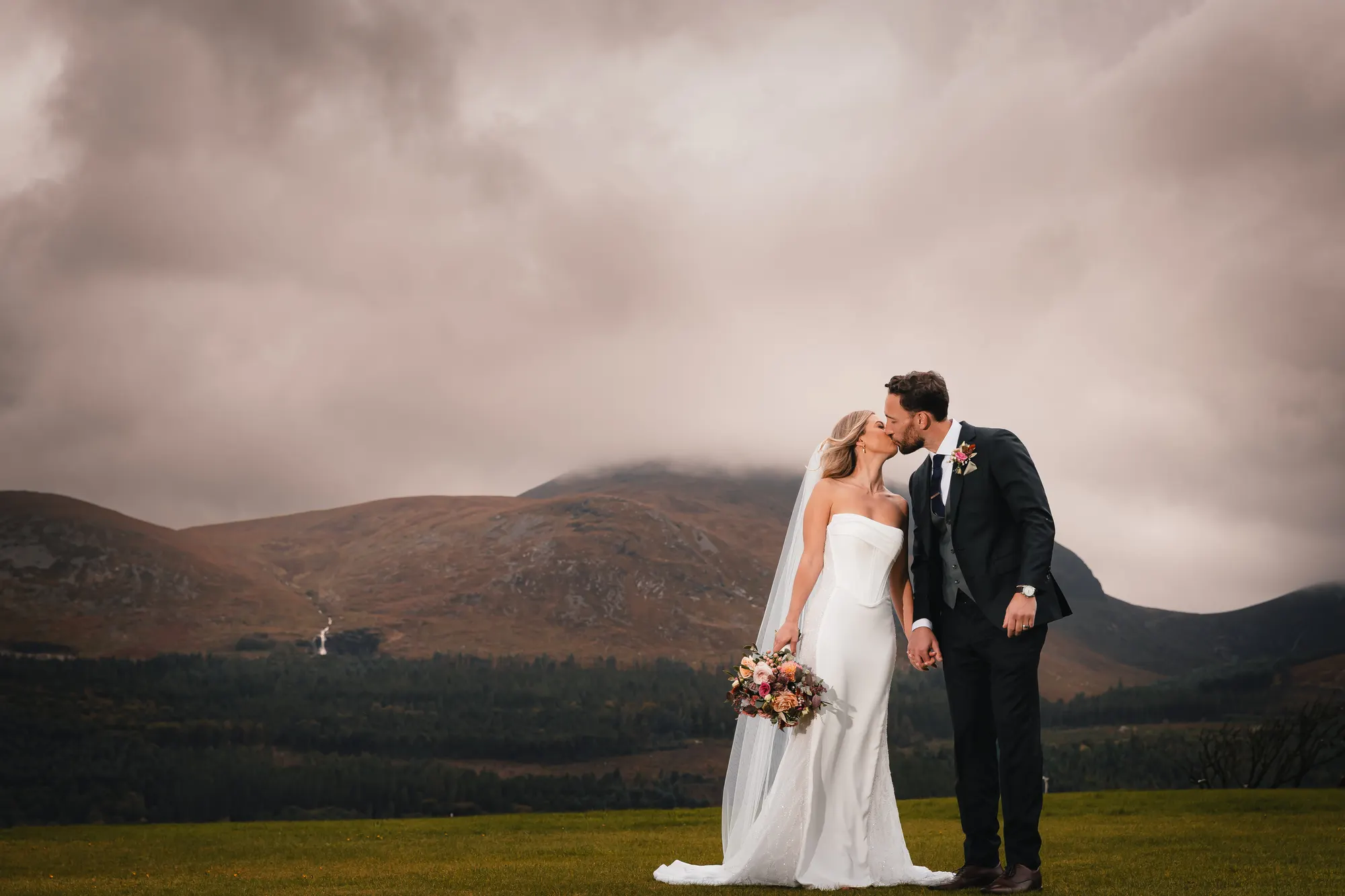 Wedding couple with the Mourne Mountains behind them at Slieve Donard