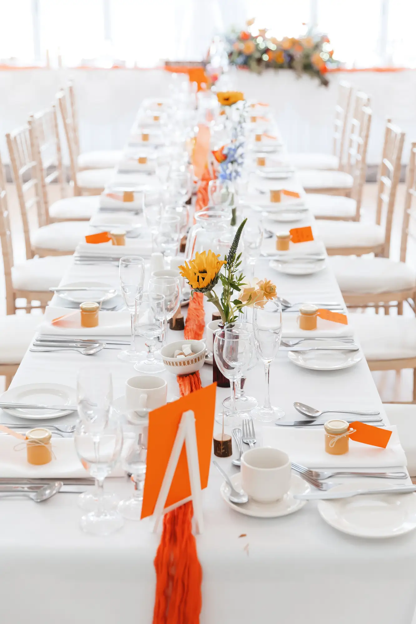Wedding reception tables prepared with flowers and place settings at Millbrook Lodge