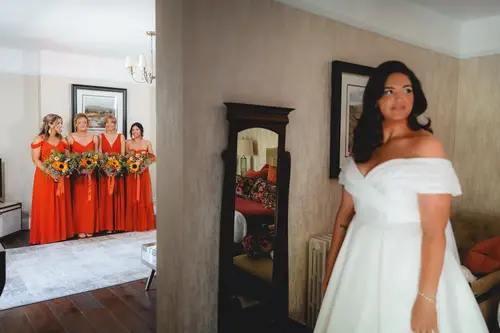 Bride and bridesmaids with bouquets during bridal prep at Millbrook Lodge, Ballynahinch