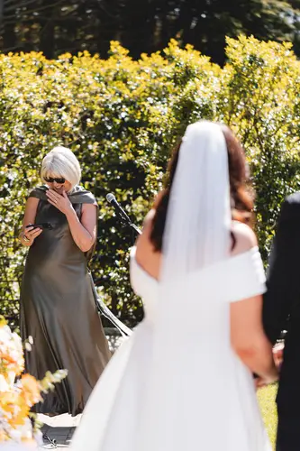 Bride sharing her vows during a sunny outdoor humanist ceremony at Millbrook Lodge in Ballynahinch