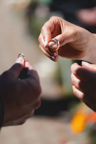 Close-up of the ring exchange during an outdoor ceremony at Millbrook Lodge in Ballynahinch