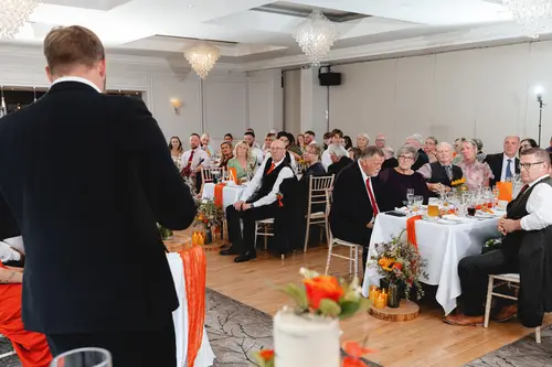 Wedding speech during the reception at Millbrook Lodge, with guests seated in a bright banquet room