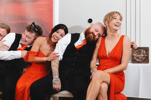 Wedding party laughing together during the indoor reception at Millbrook Lodge, Ballynahinch
