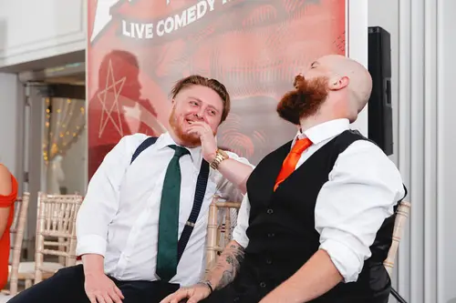 Groomsmen laughing during the evening reception at Millbrook Lodge in Ballynahinch