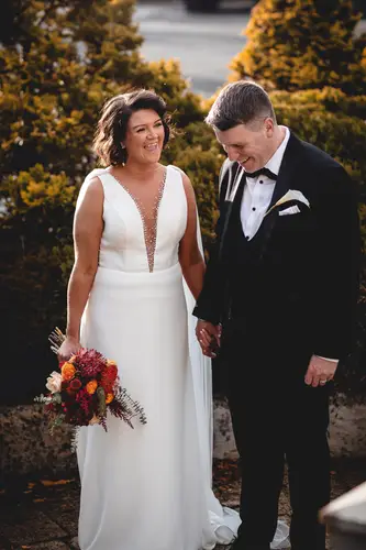 Bride and groom holding hands during golden hour portraits at Cavan Crystal in County Cavan