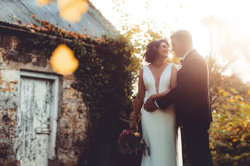 Bride and groom in warm golden hour light during outdoor portraits at Cavan Crystal in Cavan