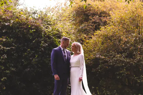 Bride and groom sharing a quiet golden hour portrait in the gardens at Old Rectory, Killyman
