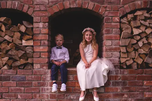 Flower girl and page boy portrait against the brick backdrop at Old Rectory, Killyman in soft natural light