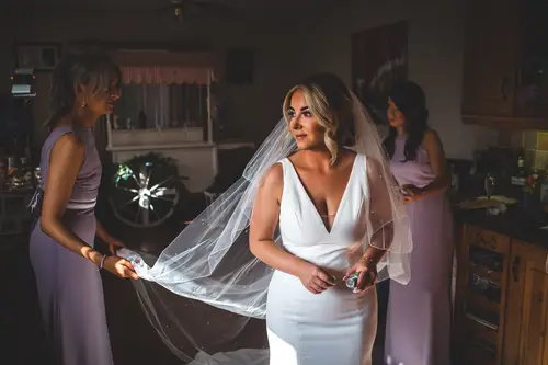 Bride and bridesmaids getting ready in soft window light at Redcastle Hotel, Moville