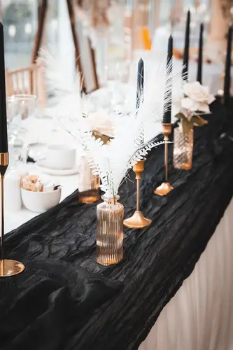 Black linen tablescape with feather centrepieces and candles at Rossharbour Resort, Lough Erne