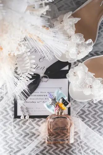 Bridal shoes, perfume and wedding invitation in a soft light flat lay at Rossharbour Resort