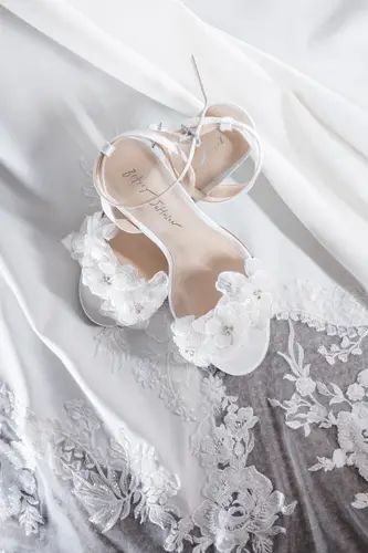 White bridal heels and lace dress details in soft light at Rossharbour Resort, County Fermanagh