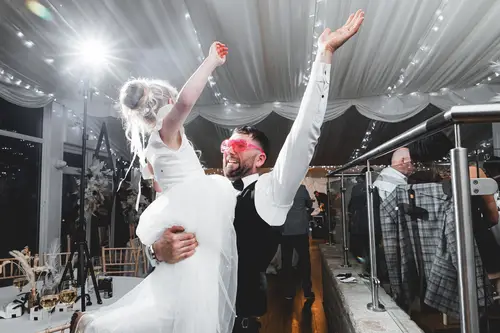 Bride and groom dancing on a backlit dance floor during an evening reception at Rossharbour Resort, Lough Erne