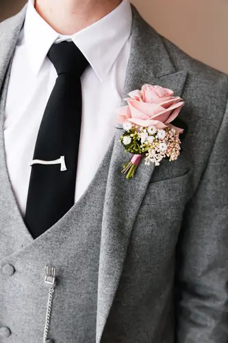 Close-up of a floral buttonhole on a grey suit during wedding morning preparations at Stormont in Belfast