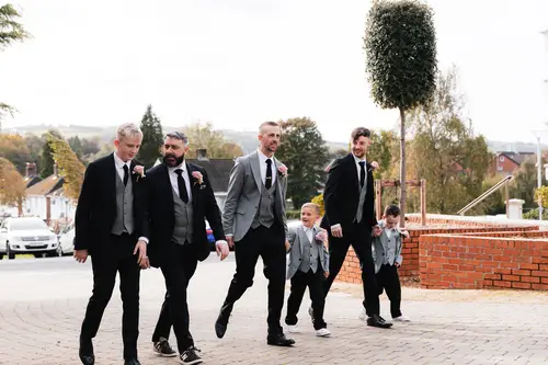 Groomsmen and page boys on an outdoor walkway during wedding preparations at Stormont in Belfast