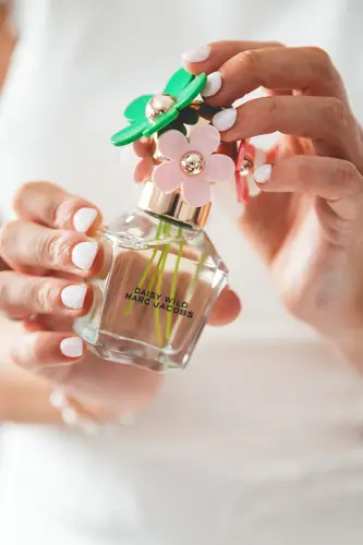 Close-up of bridal perfume and manicured hands during morning prep at Stormont in Belfast