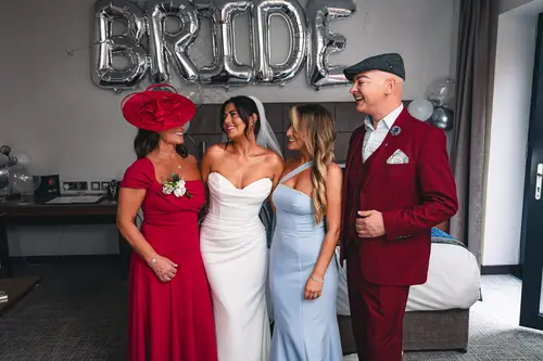 Joyful bridal party and family portrait indoors at Ten Square, Belfast, during the wedding morning