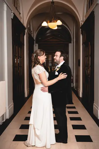 Bride and groom portrait in a softly lit arched corridor at Ulster Museum, Belfast