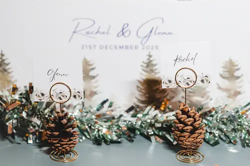 Place cards and pine cone table decor for a winter wedding reception at Ulster Museum in Belfast
