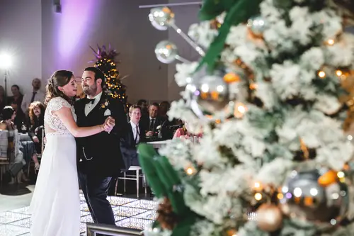 First dance at an Ulster Museum wedding reception in Belfast with soft lighting and festive decor